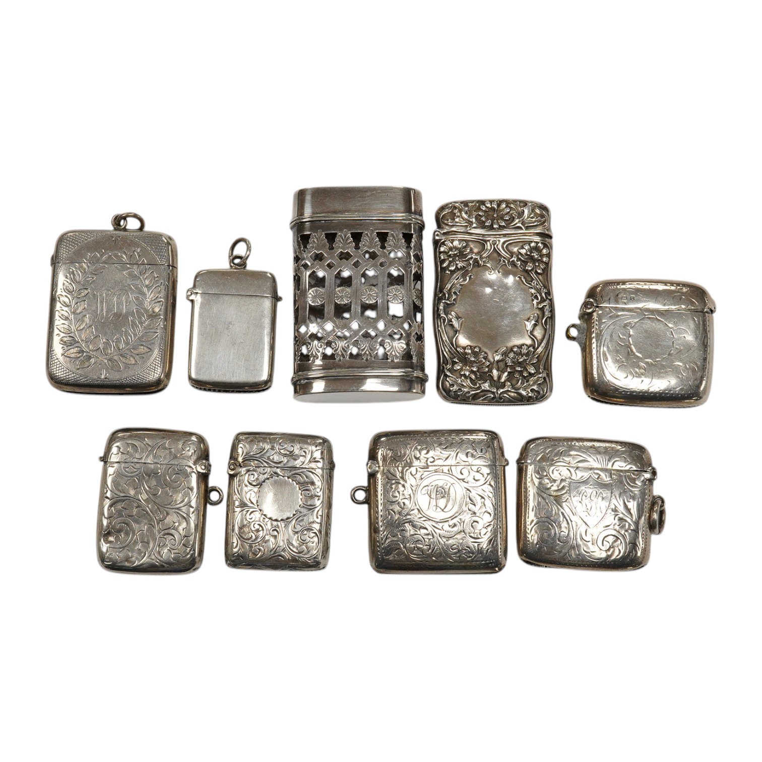 Seven assorted late 19th/early 20th century silver vesta cases, largest 48mm, a sterling case and one other pierced white metal case. Condition - poor to fair